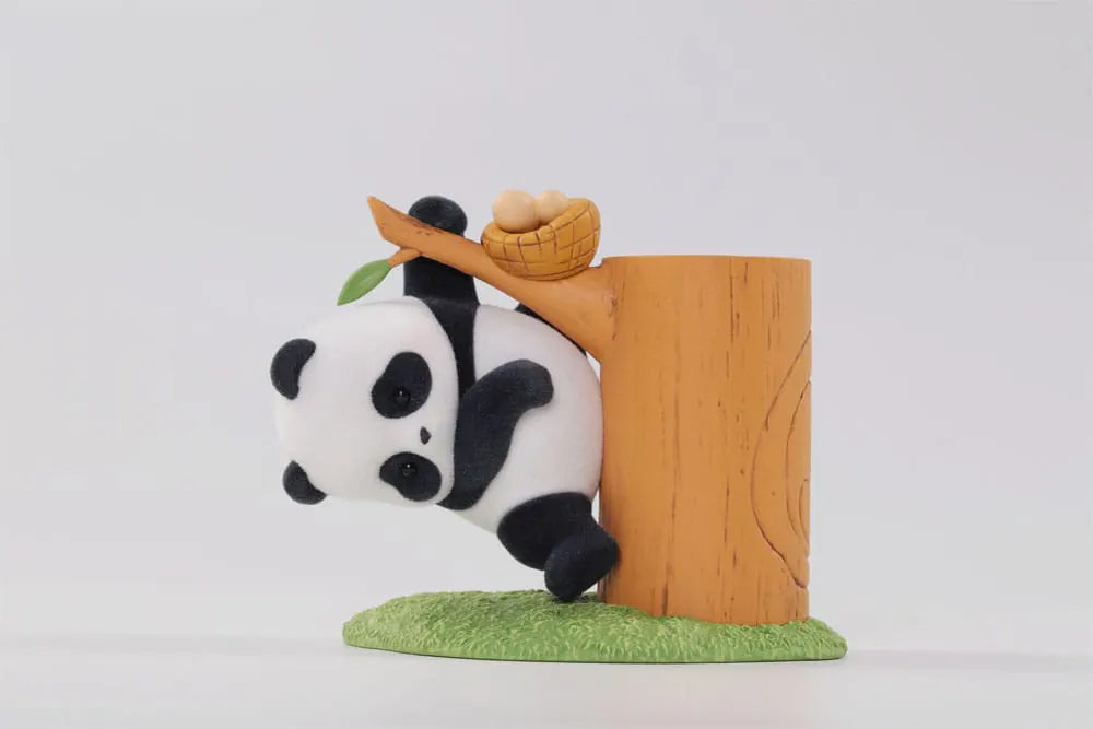 Vinyl panda toy with a basket of eggs on a tree branch