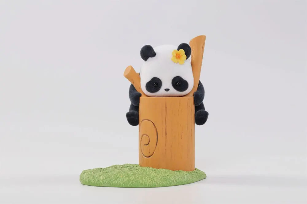 Cute panda with flower on head sitting inside a tree trunk
