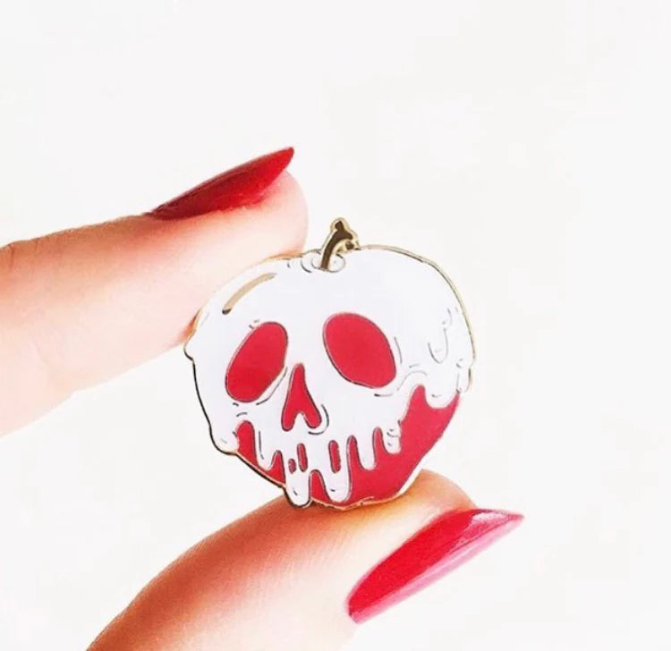 Spooky fairytale-inspired apple pin with white skull drip detailing