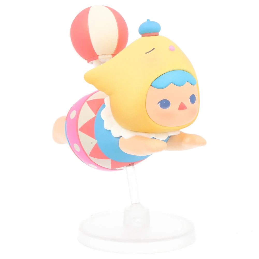 Circus-style Pucky Flying Baby with yellow hat, balloon, and colorful costume.