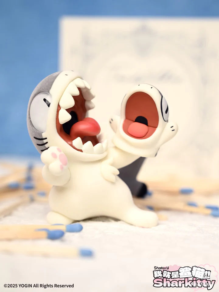 Two Sharkitty blindbox figures with wide open mouths playfully roaring