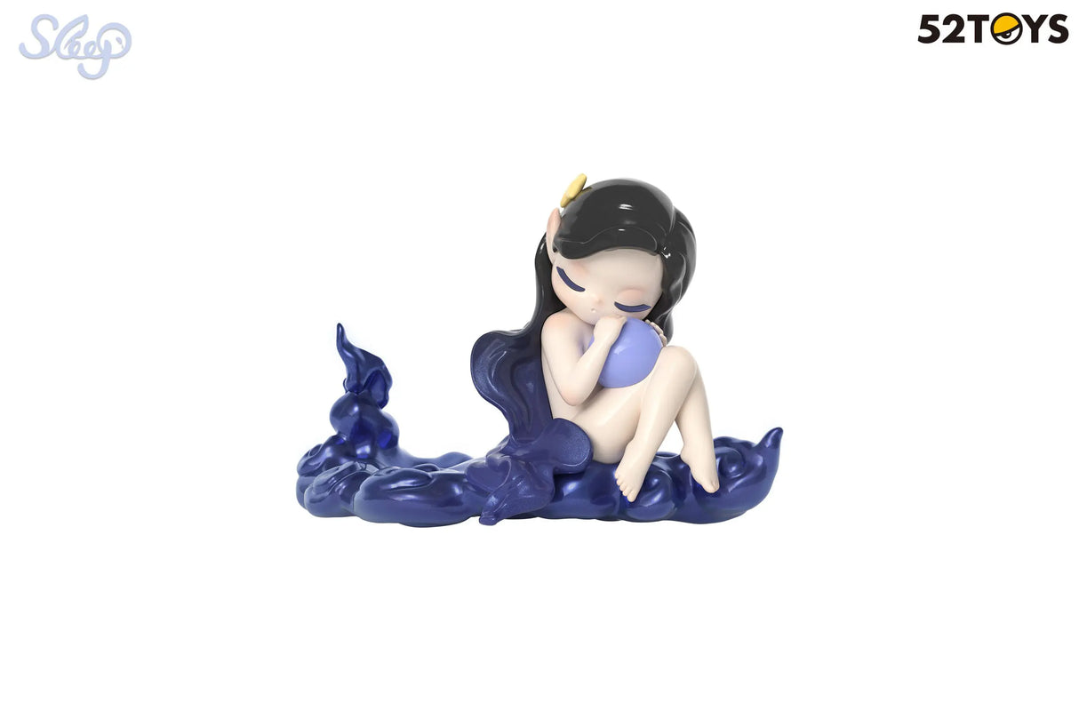 Sleep blind box vinyl figure with navy swirls and a moon-like sphere, resting pose.