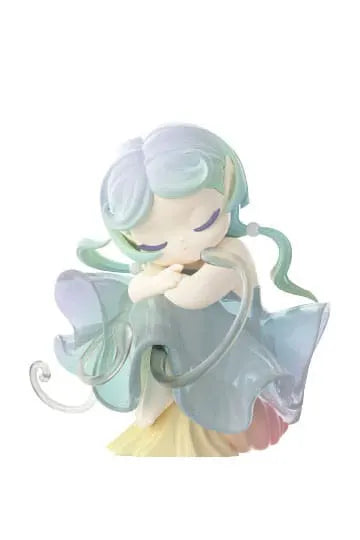 Sea elf with a translucent flowing blue and green dress, dozing with curled arms.