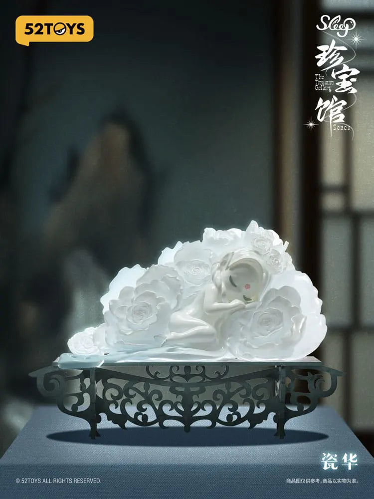 White Sleep series figure lying in rose petals on an ornate display base by 52TOYS