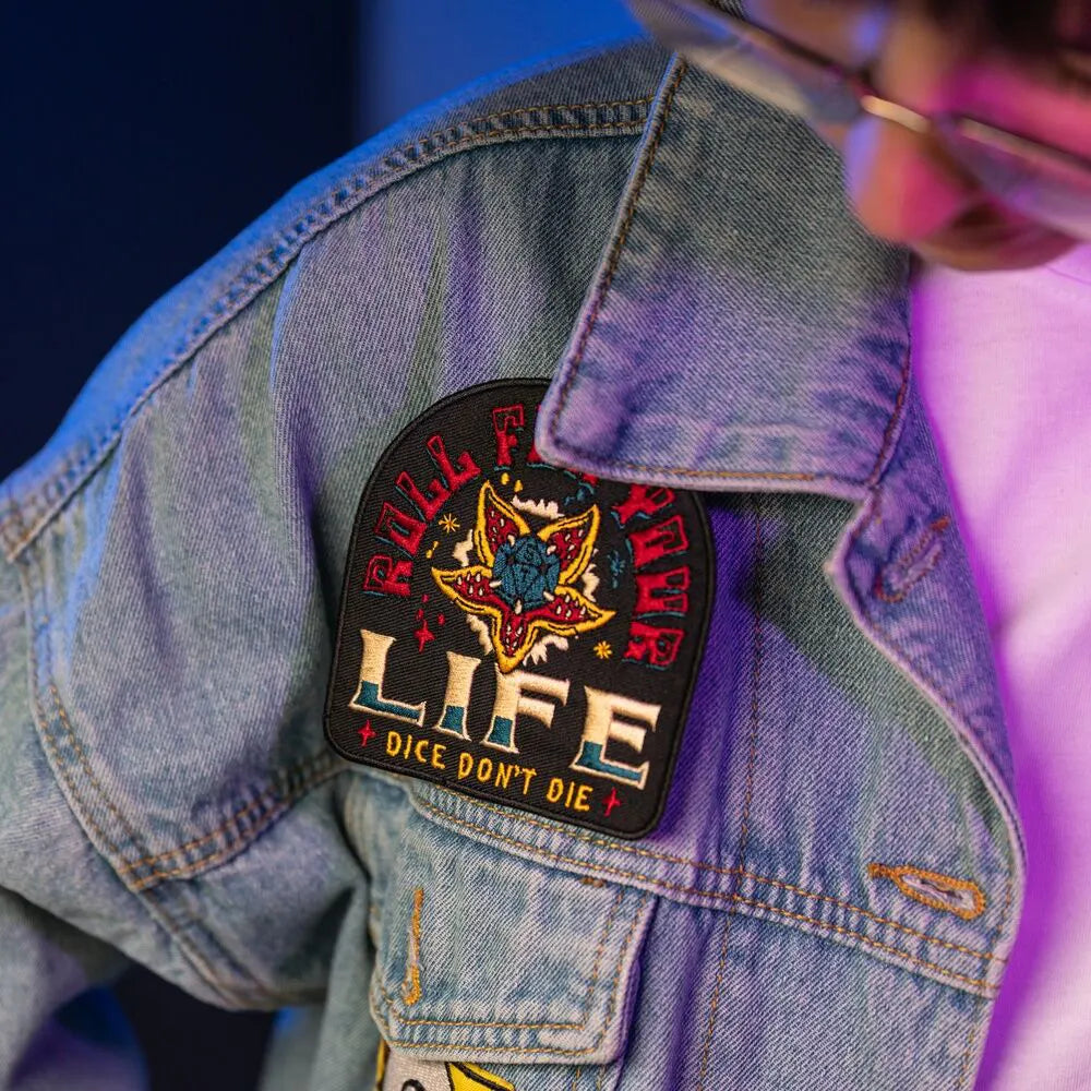 Stranger Things Roll for Your Life patch on denim sleeve