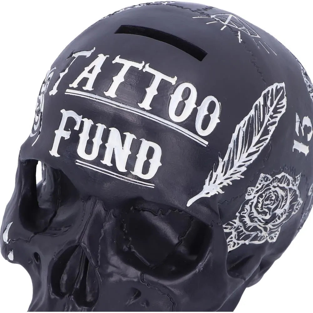 Close-up of white tattoo patterns on front of black skull bank