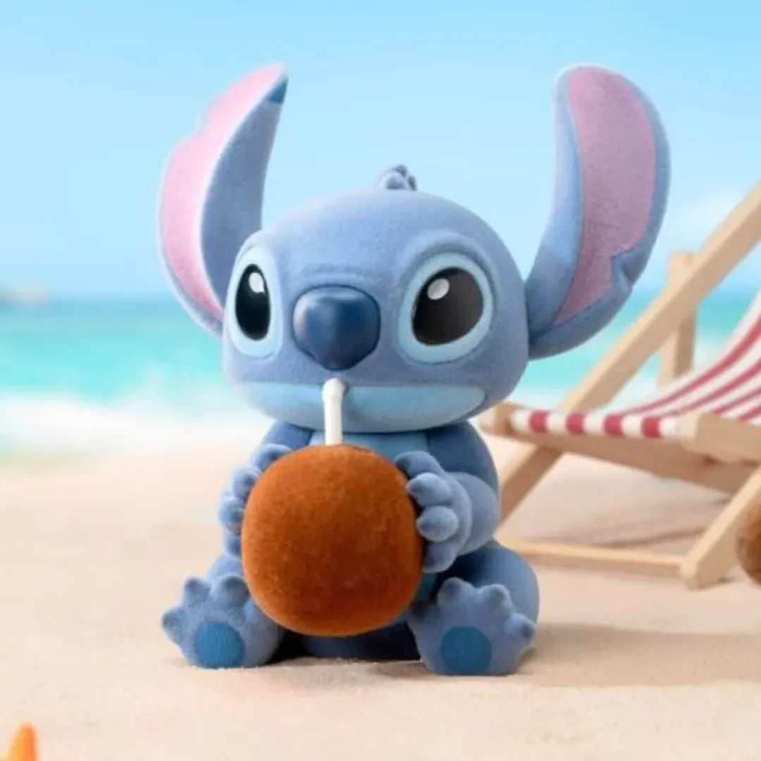Cute Stitch figure sitting on the beach sipping from a coconut