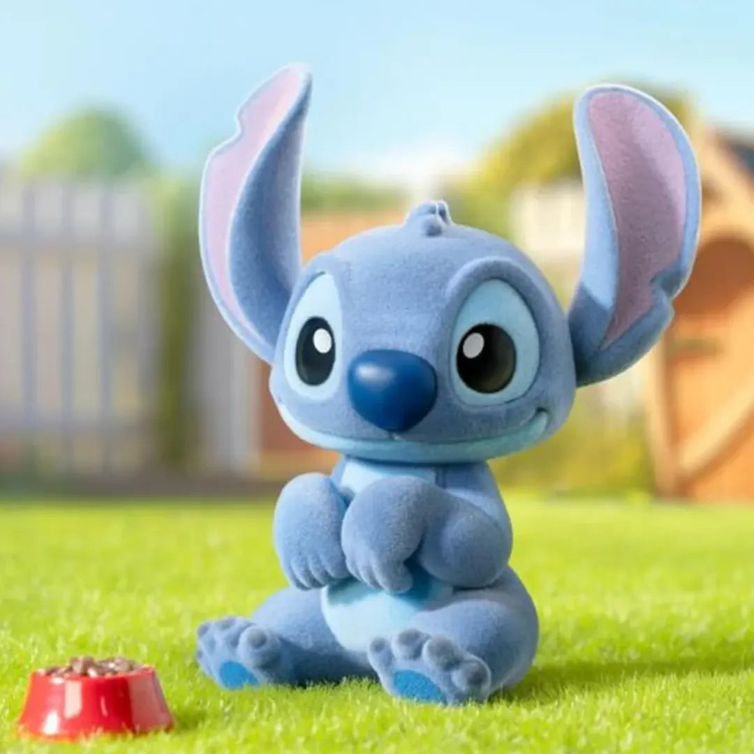 Flocked Stitch vinyl figure sitting on grass with a red food bowl