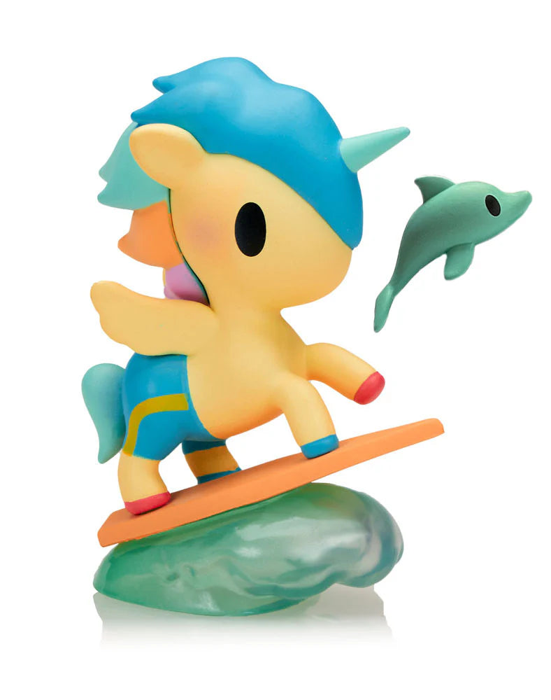 Fun in the Sun Unicorno figure surfing on an orange surfboard with dolphin companion