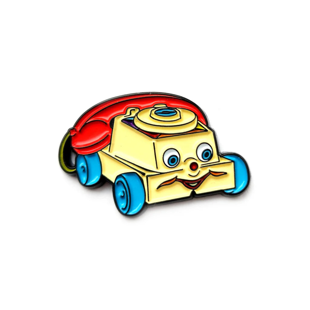 Toy phone enamel pin with colorful wheels and rotary dial design