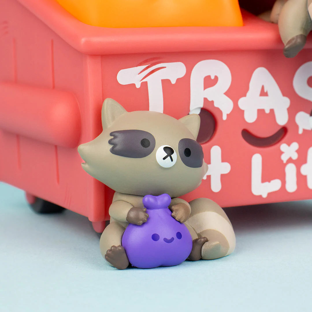 Detailed close-up of raccoon figure sitting on dumpster lid holding food bag