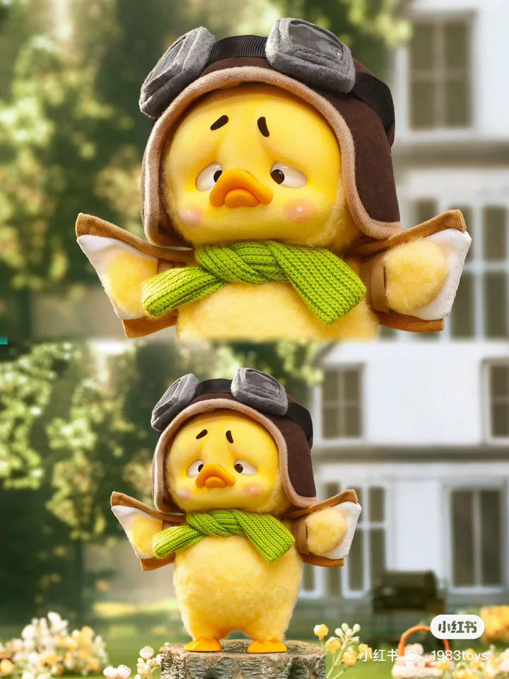 Upset Duck aviator edition wearing pilot hat and green scarf in garden scene