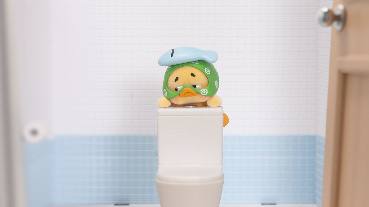 Upset Duck bathroom mood vinyl figure sitting on toilet display setup