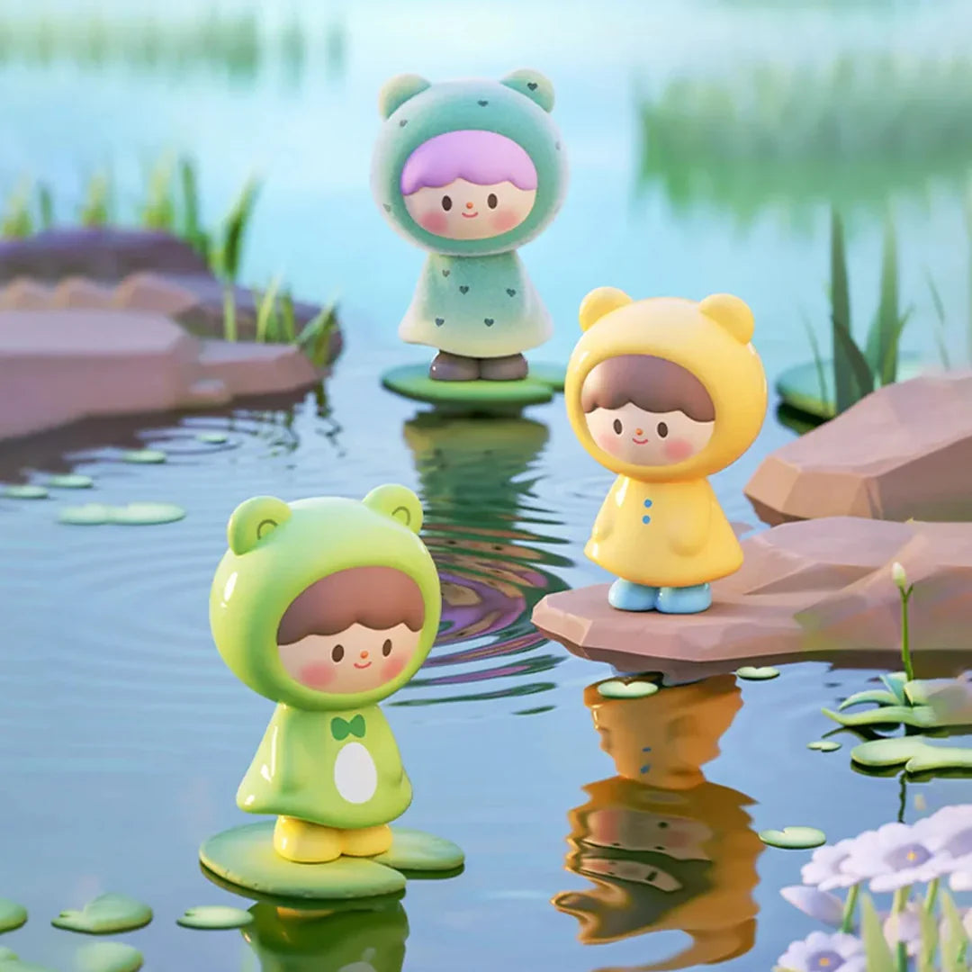Frog-themed UliUli collectible figures standing on lily pads beside a peaceful pond