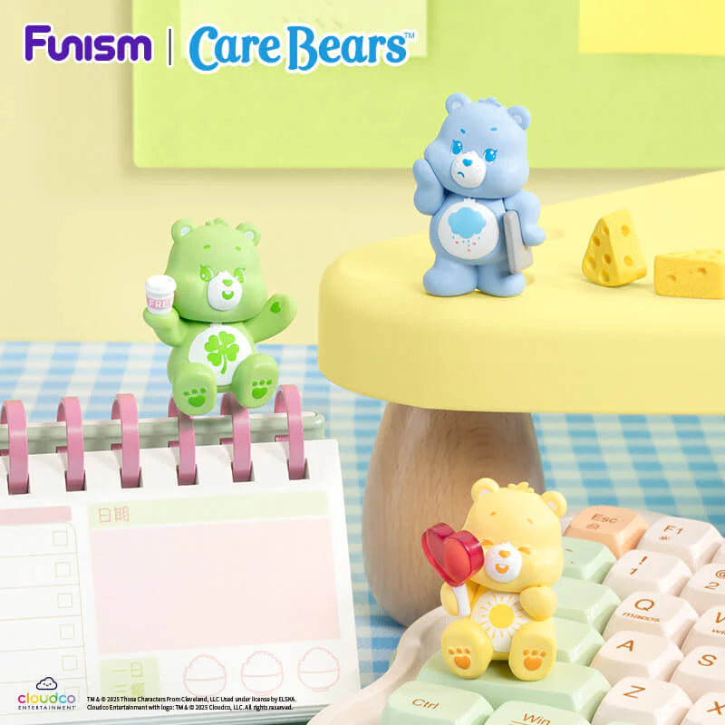 Care Bears Little Things Cubby Face Series figures posing with everyday accessories on a keyboard and desk