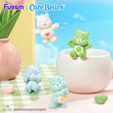 Care Bears Little Things Cubby Face Series featuring several bears gathered around a flower pot