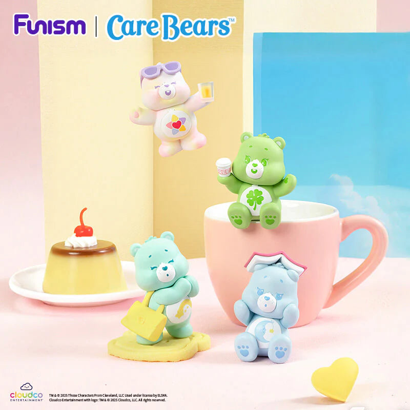 Care Bears Little Things Cubby Face Series figures displayed beside a mug and dessert