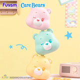 Large pastel Care Bears Cubby Face accessories stacked together with mini Care Bears figures