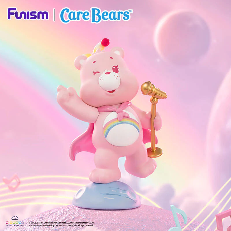 Cheer Bear from the Care Bears Planet of Joy Series singing into a golden microphone on a rainbow stage