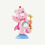 Close-up of Cheer Bear from the Care Bears Planet of Joy Series with rainbow belly badge and microphone