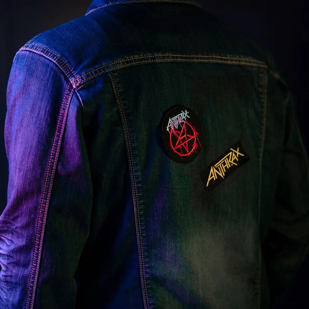 Anthrax pentagram and logo patches applied on the back of a denim jacket