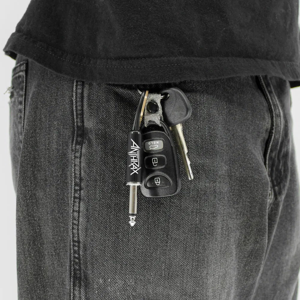 Anthrax plug keychain attached to keys in pocket