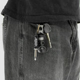 Anthrax plug keychain attached to keys in pocket