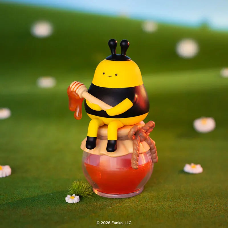 Blonks honey bee figure holding honey dipper on jar