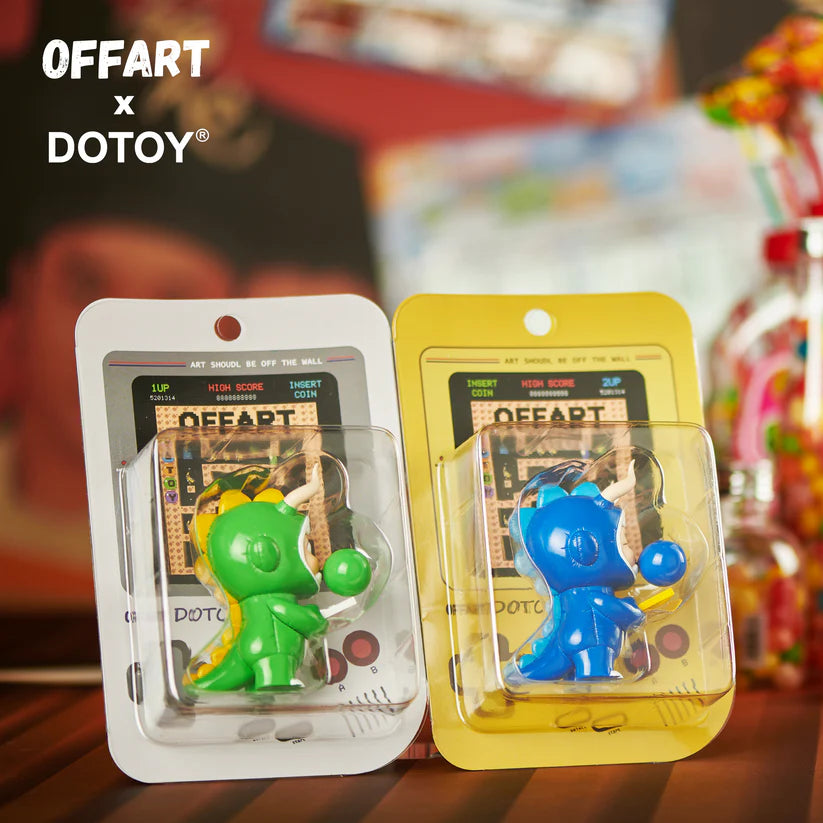 Green and blue Bubble Dino figures displayed together with arcade card packaging