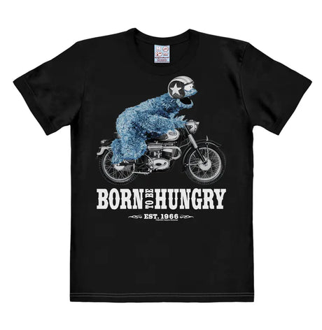 Black T-shirt featuring Cookie Monster riding a motorcycle with the text “Born To Be Hungry – Est. 1966” in bold white print.