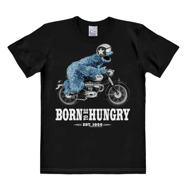 Black T-shirt featuring Cookie Monster riding a motorcycle with the text “Born To Be Hungry – Est. 1966” in bold white print.