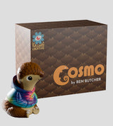 Cosmo art vinyl figure displayed next to Kaleidos Creative packaging box