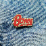 David Bowie Diamond Dogs logo enamel pin on denim jacket pocket