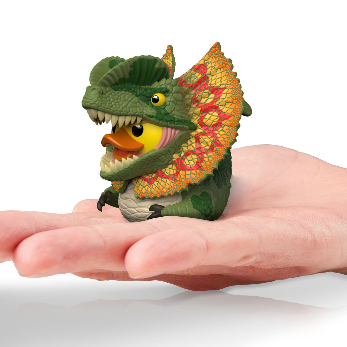 Dilophosaurus Mini TUBBZ duck figure resting in a human palm for scale.