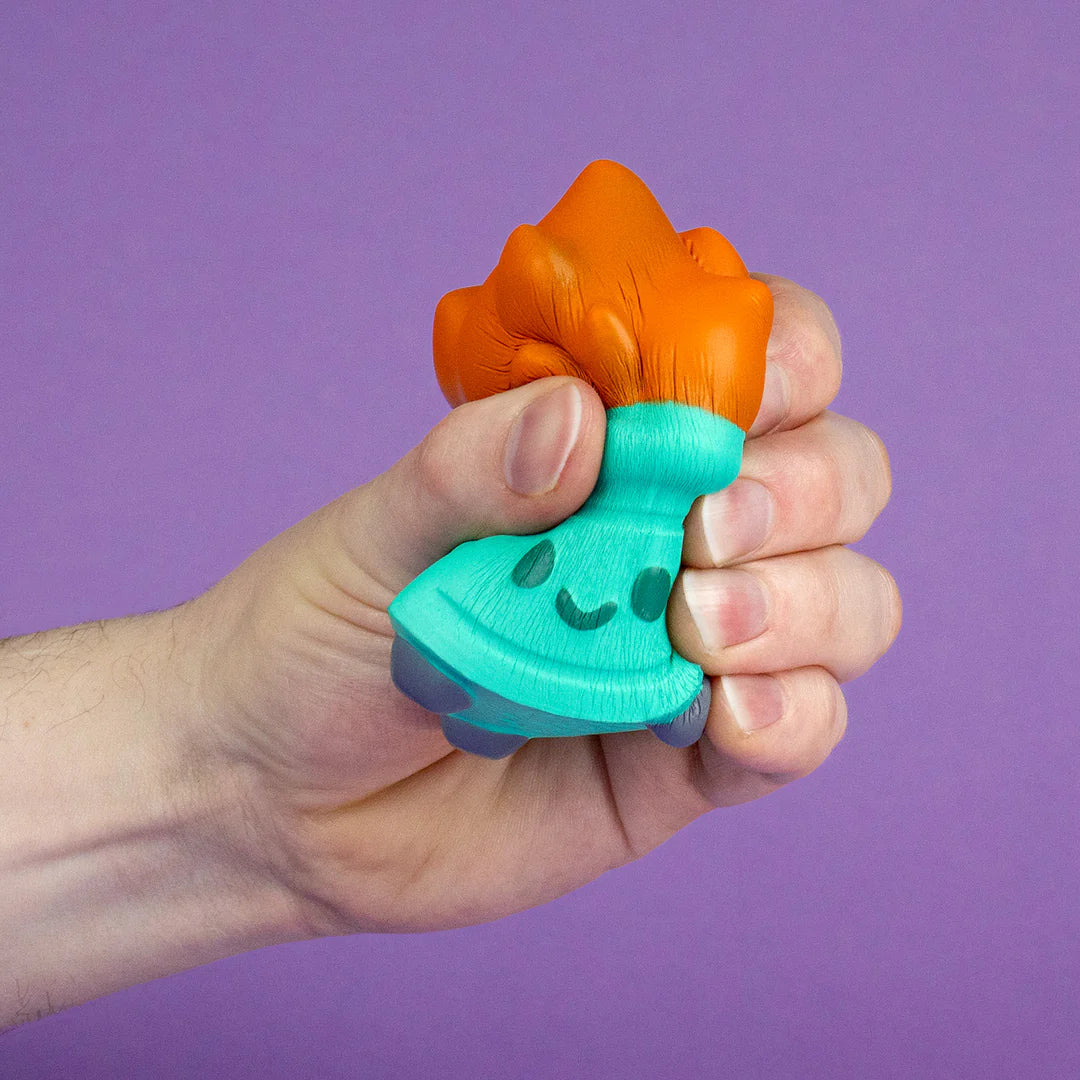 Hand squeezing Dumpster Fire stress squishy showing slow-rise foam