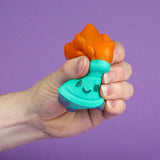 Hand squeezing Dumpster Fire stress squishy showing slow-rise foam