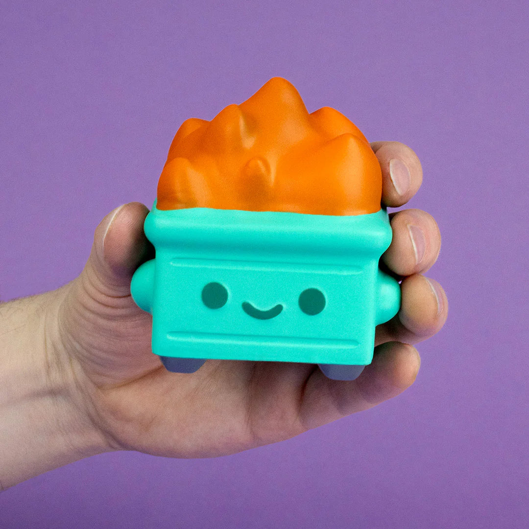 Dumpster Fire stress squishy compressed in hand against purple background