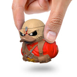 Eddie The Trooper Mini TUBBZ being held between fingers to show size.