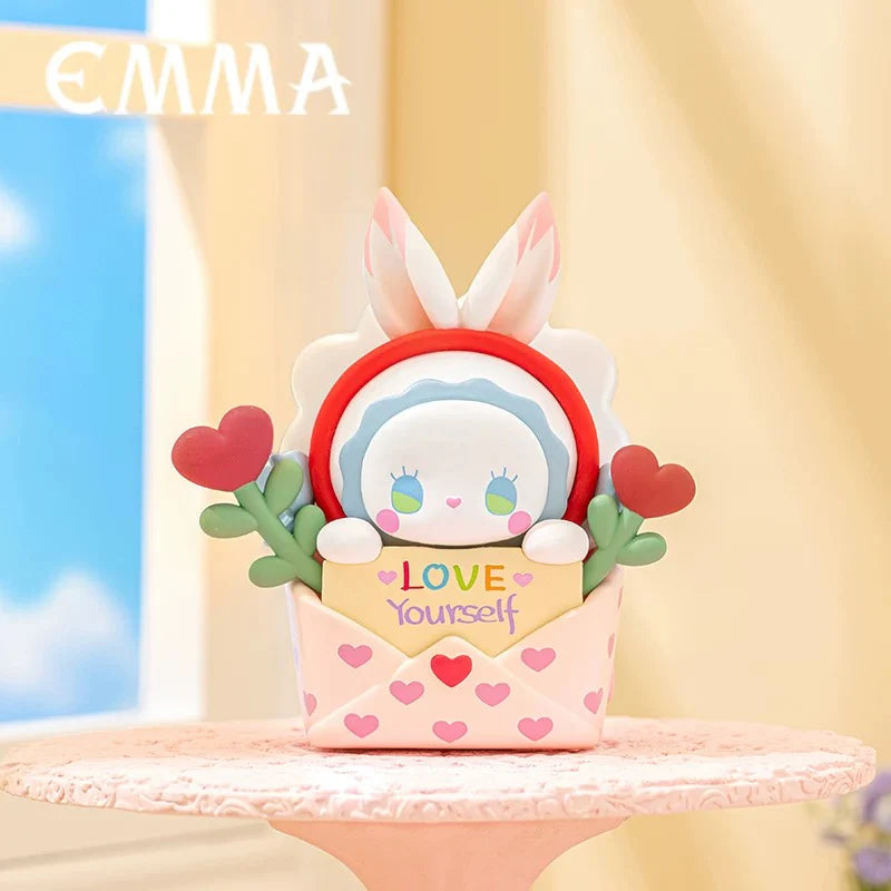 Love Letter Emma figure from Love Dopamine series holding a “Love Yourself” card inside a heart-filled envelope.