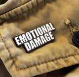 Emotional Damage enamel pin displayed on a khaki jacket