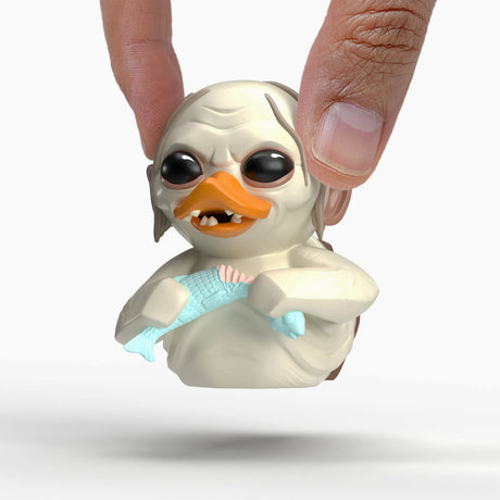 Gollum Mini TUBBZ duck being held between fingers, showing detailed face and fish