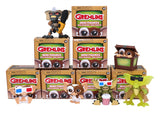 Display of multiple Gremlins Blind Box Wave 1 packages and figures including Stripe and Gizmo.