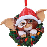 Close-up of Gizmo wearing a Santa hat in a festive wreath