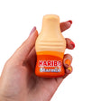 Haribo Cola Bottle Stress Squeezer held in hand showing orange and cream bottle design.