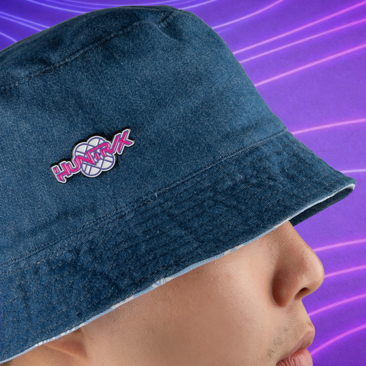 HUNTRIX pin attached to blue bucket hat