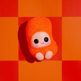 Ultra-rare Hyojo Cheetos Puff orange textured plush collectible on orange checkerboard background.
