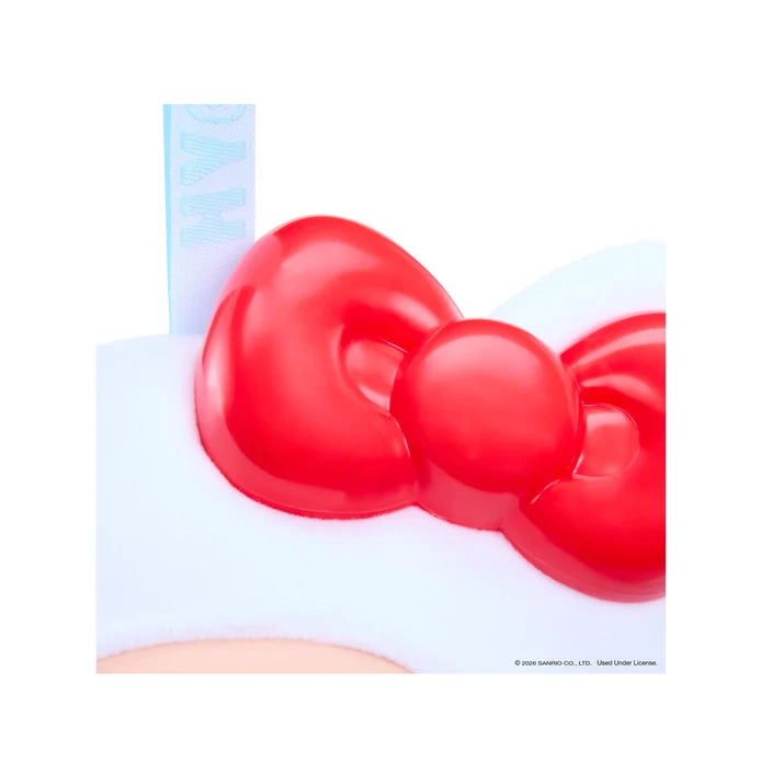Close-up of Hello Kitty's glossy red bow on Hyojo plush collectible with white cat costume.