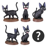 Close-up of Jiji PVC mini figures from Kiki’s Delivery Service blind box series on round bases.