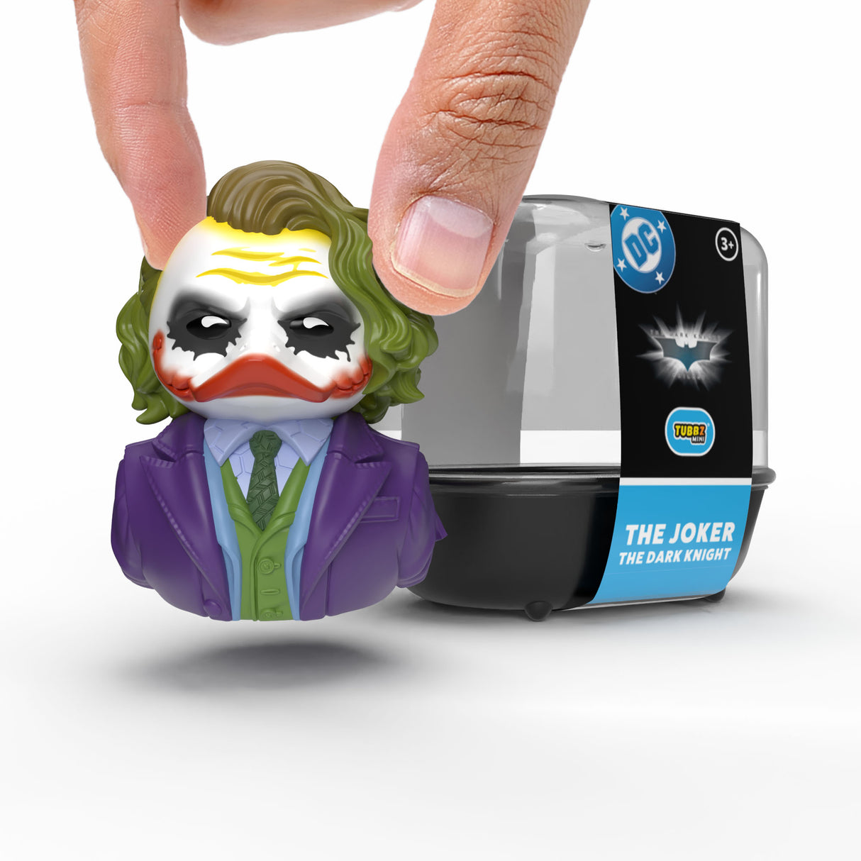 Mini Joker TUBBZ duck being held by fingers in front of packaging