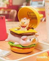 LuLu The Piggy transformed into a giant cheeseburger with a cat employee popping out from the top bun